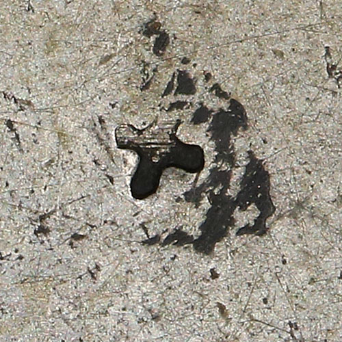 Small '+' shaped chopmark